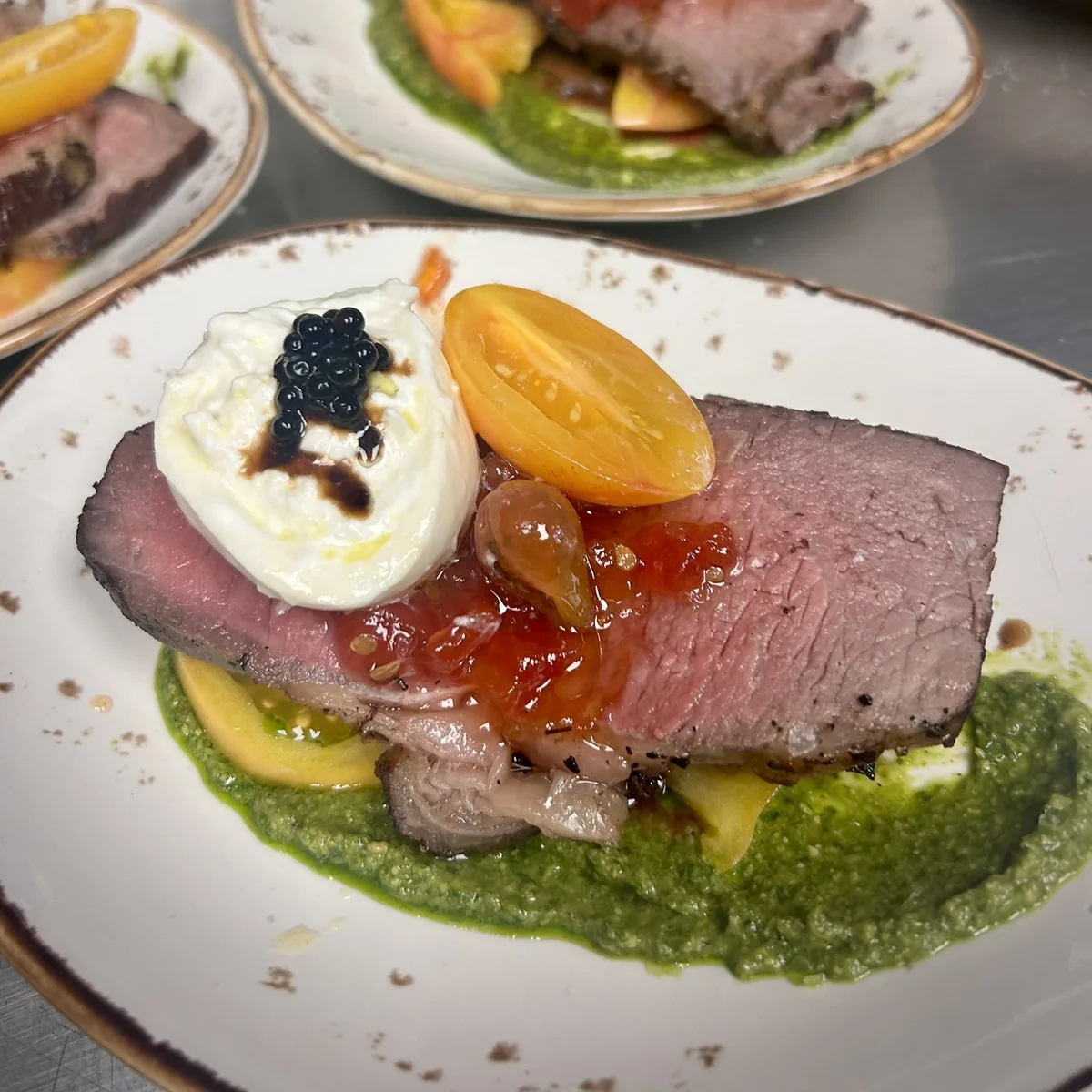 New York Strip Steak with creme fresh, caviar, and a Pesto sauce